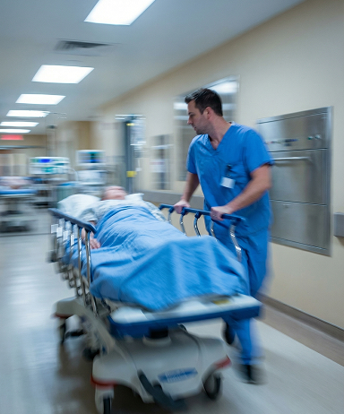 Healthcare worker moving a patient